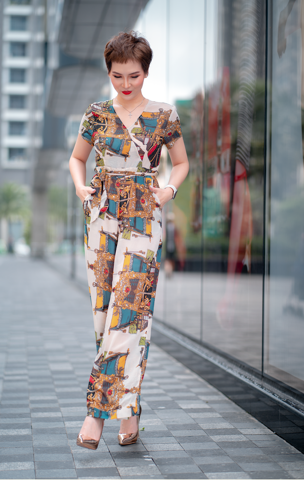 Woman in Printed Jumpsuit Standing on Gray Concrete Flooring